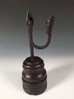 A late 17th/early 18th century rushlight holder on turned wooden base, possibly East Anglian, the ho