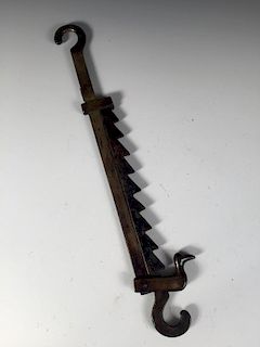 A late 18th/early 19th century brass adjustable pot hook, opposing hooks at each end, the saw toothe