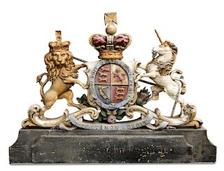 A late 19th/early 20th century polychrome wood Royal Arms, crown crested above the motto belted armo