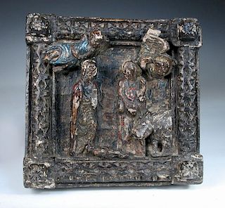 A 16th century Continental carved chestnut and polychrome decorated panel of the Nativity, the squar