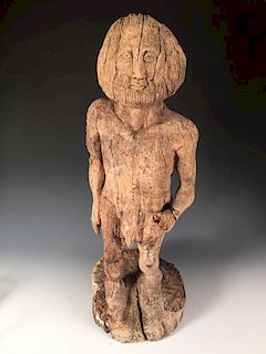 A Mediaeval style carved wood figure, possibly of Adam, the bearded figure naked with his left hand
