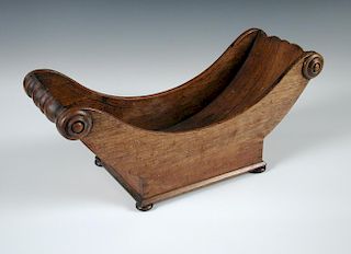 A 19th century mahogany cheese coaster, the curve shaped body raised on four bun feet 19 x 44cm (7 x