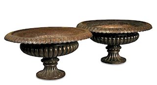 A pair of Regency style cast iron urns, with cast egg and dart rims to fluted spreading circular fee