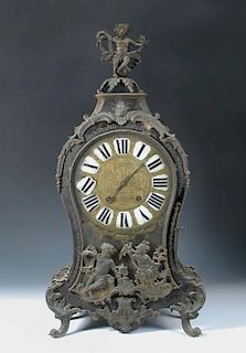 A French 18th century Boullework mantel clock, the waisted case with gilt metal mounts, enamelled nu