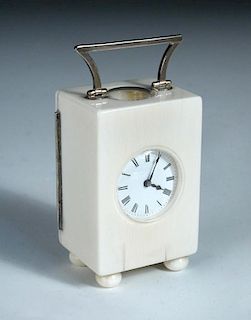 A French ivory cased miniature carriage timepiece, with shaped silver handle and hinge to the rear d