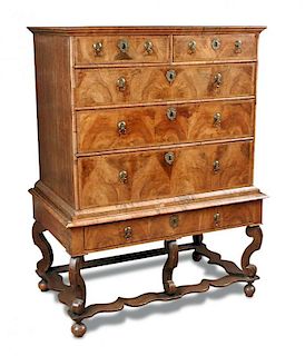 A William & Mary walnut chest on stand, with feather banded border decoration, brass drop handles, p