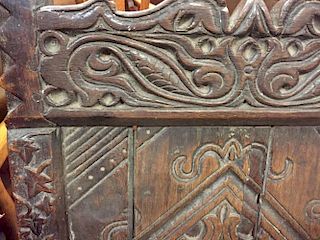 An early 17th century oak wainscote chair, carved in the Medieval style with celtic designs, mask ar