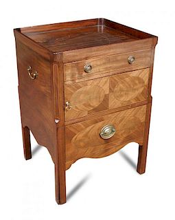A George III mahogany night table, with tray edge top, cupboard and drawer below, decorated with ova