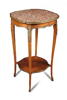 A Transitional style mahogany and rouge marble gueridon, the shaped top with gilt brass mounts with