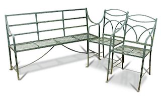 A Regency wrought iron strapwork garden seat, painted green and two similar strapwork chairs on moul