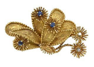 Tiffany & Company 18 Karat Gold Brooch, set with sapphires and two diamonds, length 1 5/8 inches, 12 grams.