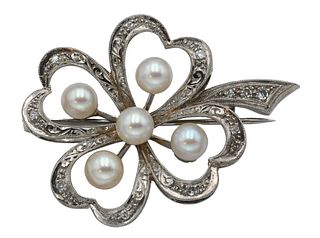 18 Karat White Gold Brooch, mounted with 5 pearls and 11 small diamonds, height 1 1/2 inches, 9 grams.