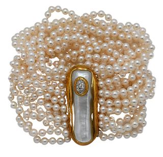Tambetti 17 Strand Pearl Bracelet, having 18 karat gold clasp and bar closure, mounted with large pearl and small diamonds, length 6 1/4 inches.