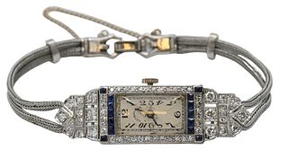 Platinum Tiffany & Company Art Deco Ladies Wristwatch, having 59 diamonds, 14 blue sapphires, dial marked Tiffany & Company, total weight 22.8 grams.
