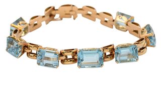 14 Karat Yellow Gold Bracelet, set with emerald cut aquamarines, 38.15 carat total weight, length 7 1/4 inches, 29.6 grams total weight.