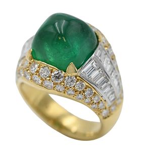 18 Karat Yellow Gold Ring, having center sugarloaf cabochon emerald surrounded by baguette emerald, 8.12 carats; 58 round cut diamonds, diamond total 
