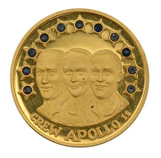 Crew Apollo 11 Gold Medallion, set with 11 sapphires, 12 1/2 grams, 28 millimeters, 21.6 karats. Provenance: Collection of Anton Peek previously from 