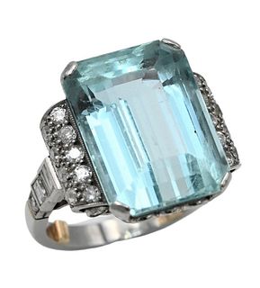Platinum Ring, set with emerald cut topaz flanked by a group of diamonds, to include 10 round, 2 baguettes, and an emerald cut on either side, topaz 1