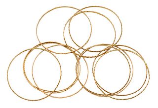 Eleven 18 Karat Gold Bracelets, diameter 2 1/2 inches, 64 millimeters diameter opening; 64 grams.