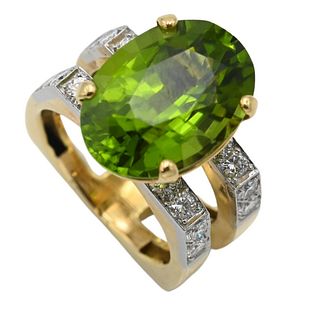 18 Karat Yellow and White Gold Double Ring, set with oval green peridot with eight diamonds on either side, size 7 3/4, 12.5 x 17.4 millimeters.