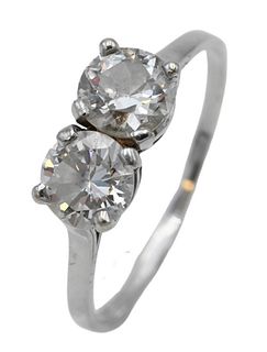 18 Karat White Gold and Diamond Ring, set with two diamonds, each approximately 6.4 millimeters, approximately one carat each, size 10 1/4. Provenance