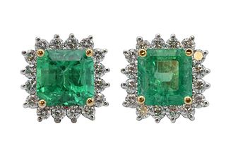 Pair of 18 Karat White Gold and Emerald Earrings, total emerald weight 5.13 carats, surrounded by 32 brilliant cut diamonds, total weight 1.17 carats;
