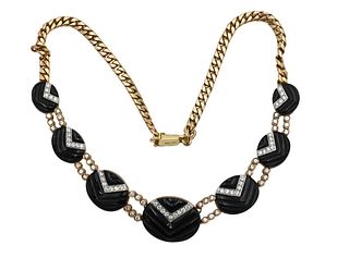 14 Karat Gold Necklace, having seven oval medallions of black onyx and diamonds, with six diamonds in between each, total weight 38.4 grams.