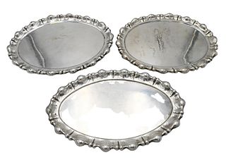 Three Austrian Silver Graduated Platters, each hand-hammered and oblong having lobed over scrolled sides, lengths 17 1/2 to 19 1/2 inches, total weigh
