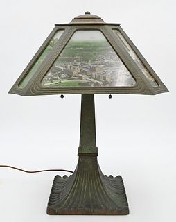 National Cash Register Table Lamp, having bronze base with photographic transfer panel shade, depicting factory landscape scene, height 19 1/2 inches.