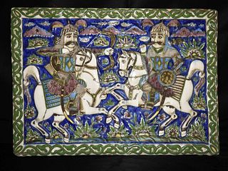 A LARGE IMPRESSIVE QAJAR MOULDED POLYCHROME POTTERY TILE 19TH CENTURY IRAN