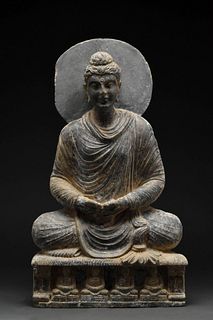 A GANDHARAN GRAY SCHIST FIGURE OF A SEATED BUDDHA