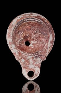 A ROMAN POTTERY OIL LAMP WITH BOAR