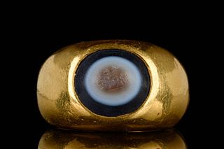 A ROMAN GOLD AND EYE AGATE FINGER RING DEPICTING A HORSEMAN WITH SPEAR