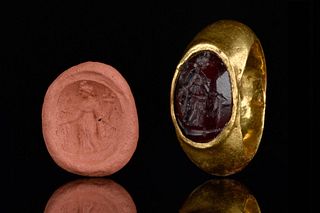 A ROMAN GOLD RING AND CARNELIAN INTAGLIO DEPICTING FORTUNA