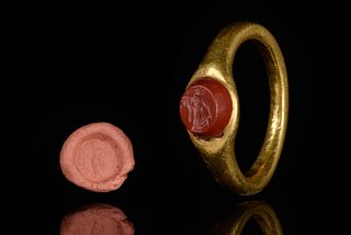 A ROMAN GOLD RING AND CARNELIAN INTAGLIO DEPICTING FORTUNA