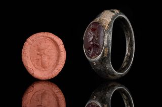 A ROMAN BRONZE RING WITH CARNELIAN INTAGLIO DEPICTING BUST OF IMPERIAL FAMIL