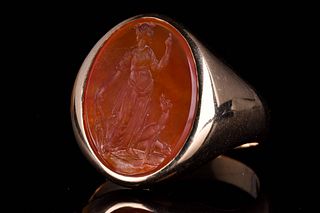 A POST CLASSICAL GOLD CARNELIAN INTAGLIO RING DEPICTING DIANA WITH HOUND