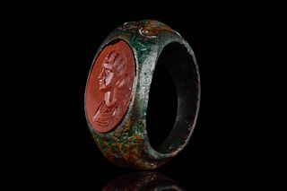 A ROMAN BRONZE RING WITH CARNELIAN INTAGLIO DEPICTING BUST OF IMPERIAL FAMILY