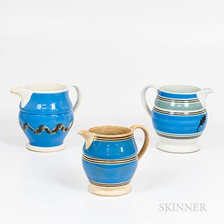 Three Mochaware Slip-decorated Pitchers with Wide Blue Bands