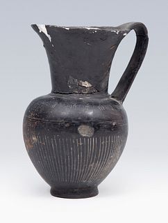 Etruscan jug. 6th century BC. 
In black bucchero. 
Measures: 14 x 10 x 9 cm.