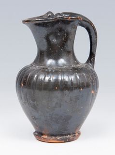 Etruscan Oinochoe, 6th century BC. 
Black glazed ceramic or bucchero. 
Measures: 10 x 7,5 x 7,5 cm.