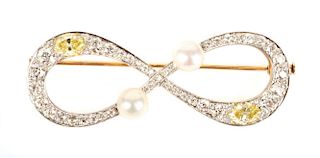A White and Yellow Diamond Infinity Brooch