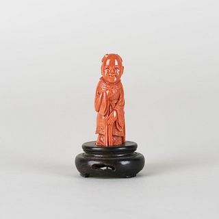 A CARVED CORAL OF FIGURE WITH STAND 