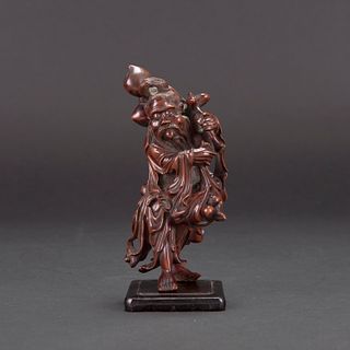 A CARVED HUANGYANG WOOD CARVING OF LONGEVITY GOD WITH STAND 