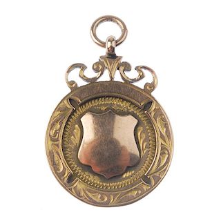 An early twentieth century 9ct gold fob medal, the circular form with applied vacant shield cartouch