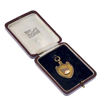 A 1920's 9ct gold fob medal, the shield form engraved to both sides. Hallmarked Birmingham 1922. Hei