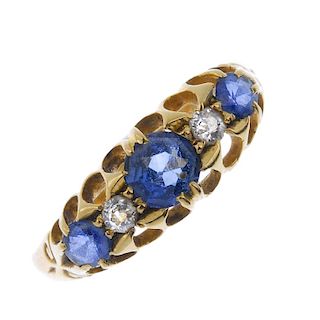 An Edwardian 18ct gold sapphire and diamond ring. The circular-shape sapphire and brilliant-cut diam