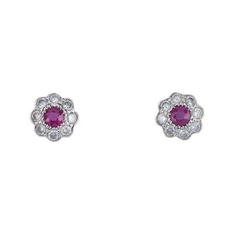 A pair of 18ct gold ruby and diamond cluster earrings and a brooch. The ear studs each designed a a