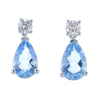 A pair of 18ct gold aquamarine and diamond earrings. Each designed as a pear-shape aquamarine, suspe
