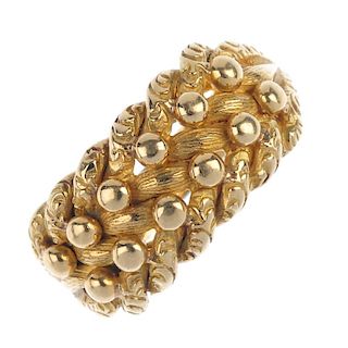 An Edwardian 18ct gold keeper ring. The bead highlight and vari-texture interwoven panel, to the tap